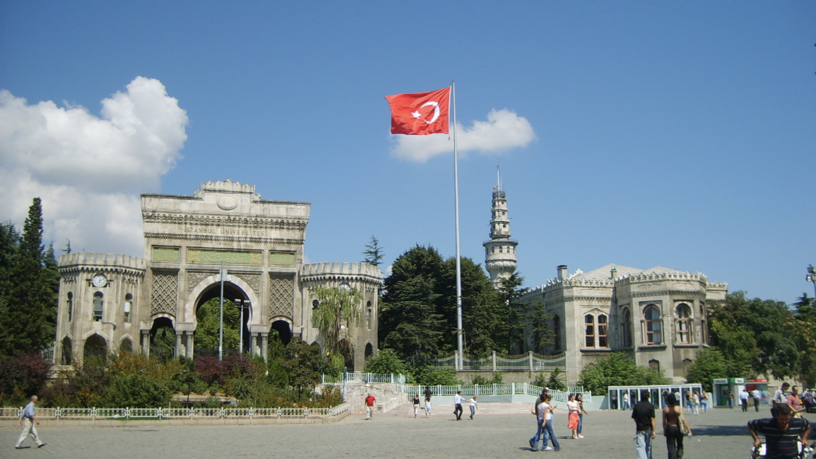A Turkish flag flies in front of the main entrance of the gate of Istanbul University