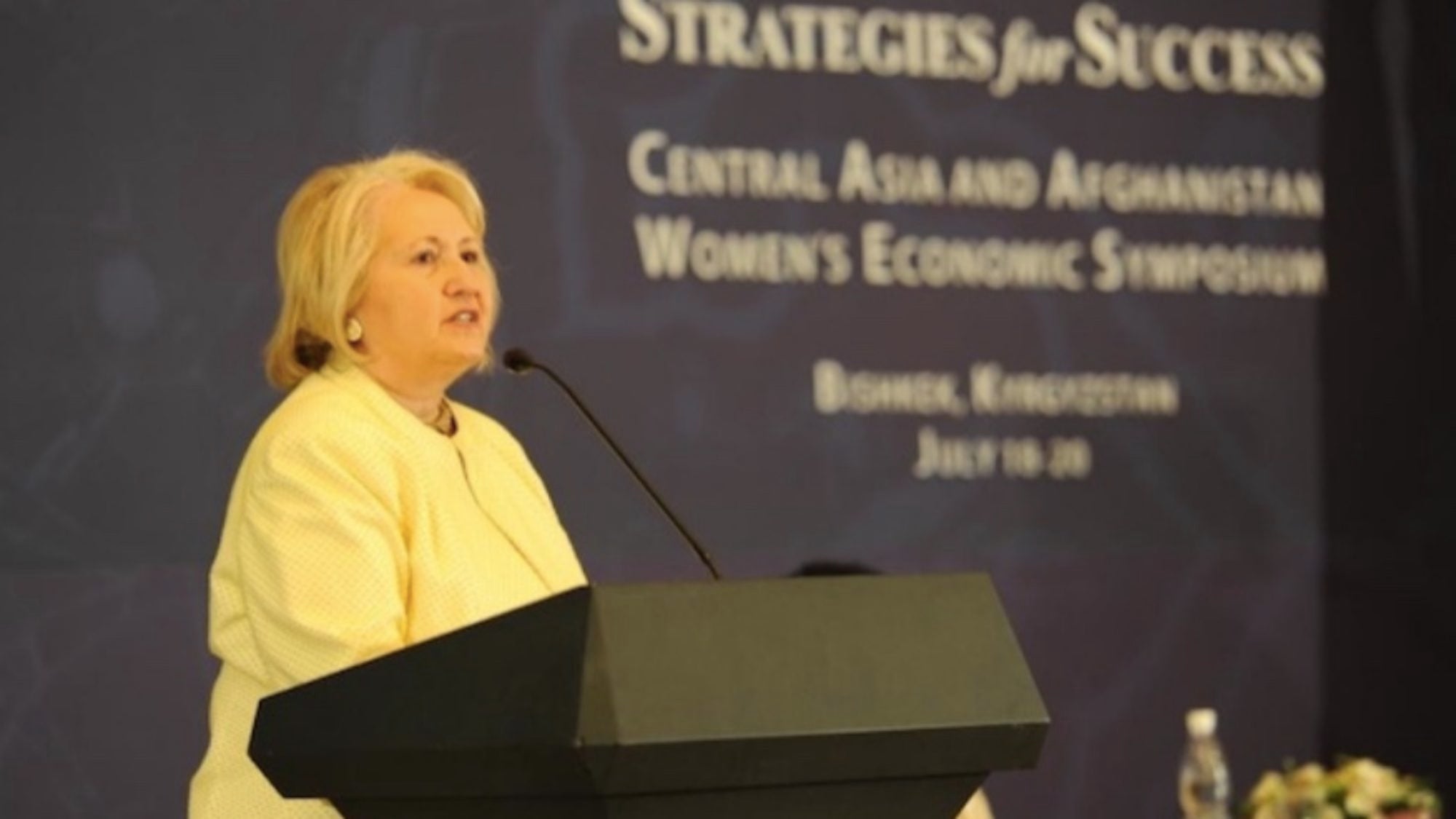 Woman speaking from a podium.