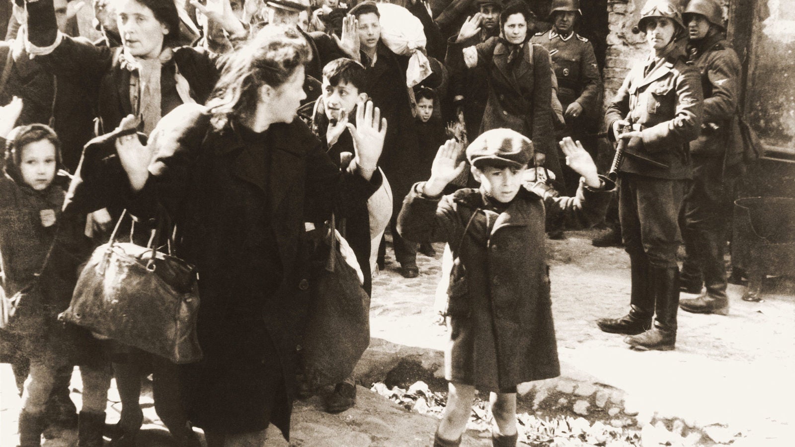 People raising their hands during the Holocaust