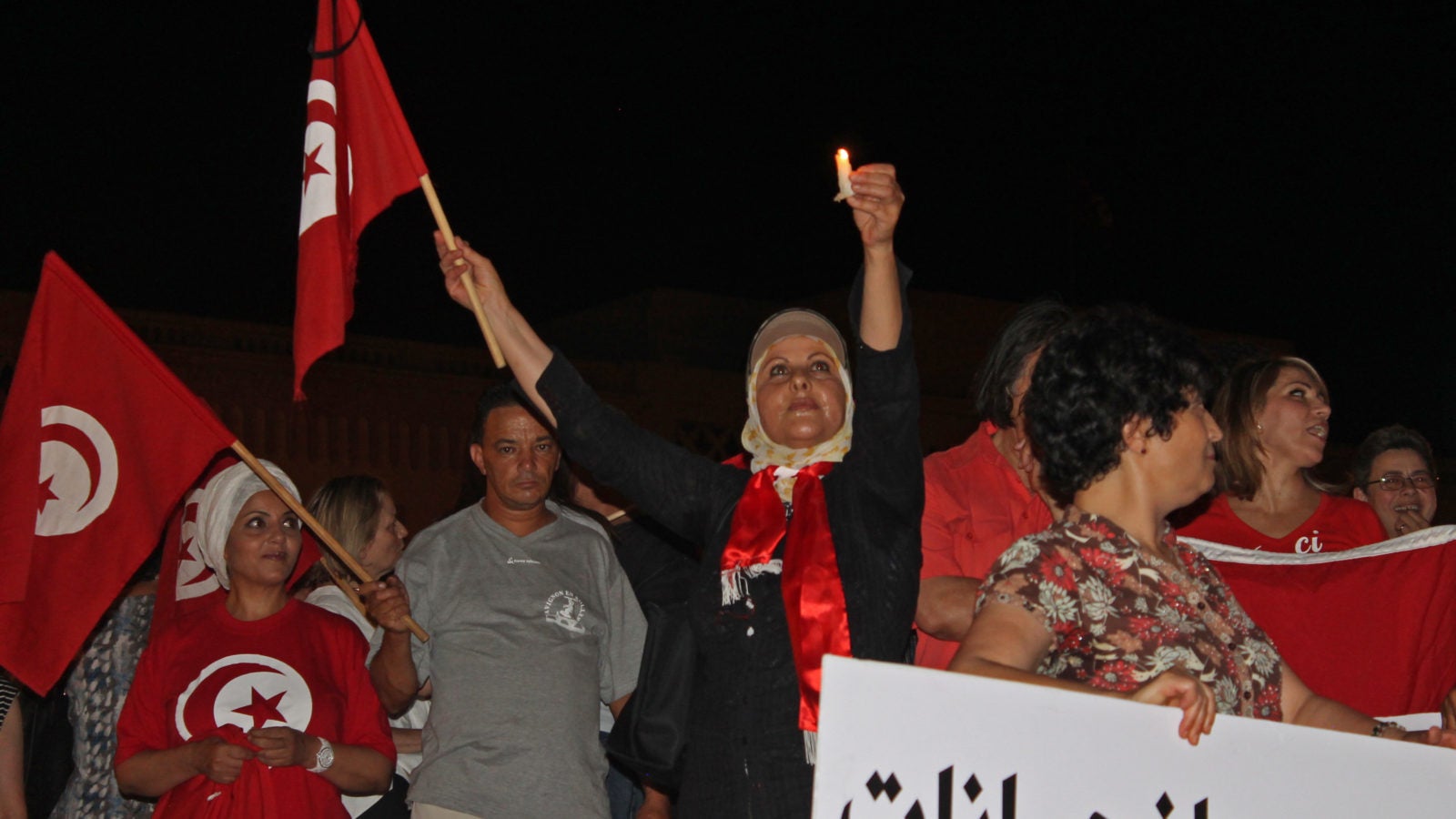 Group of anti-terrorism protestors with the Tunisian flag