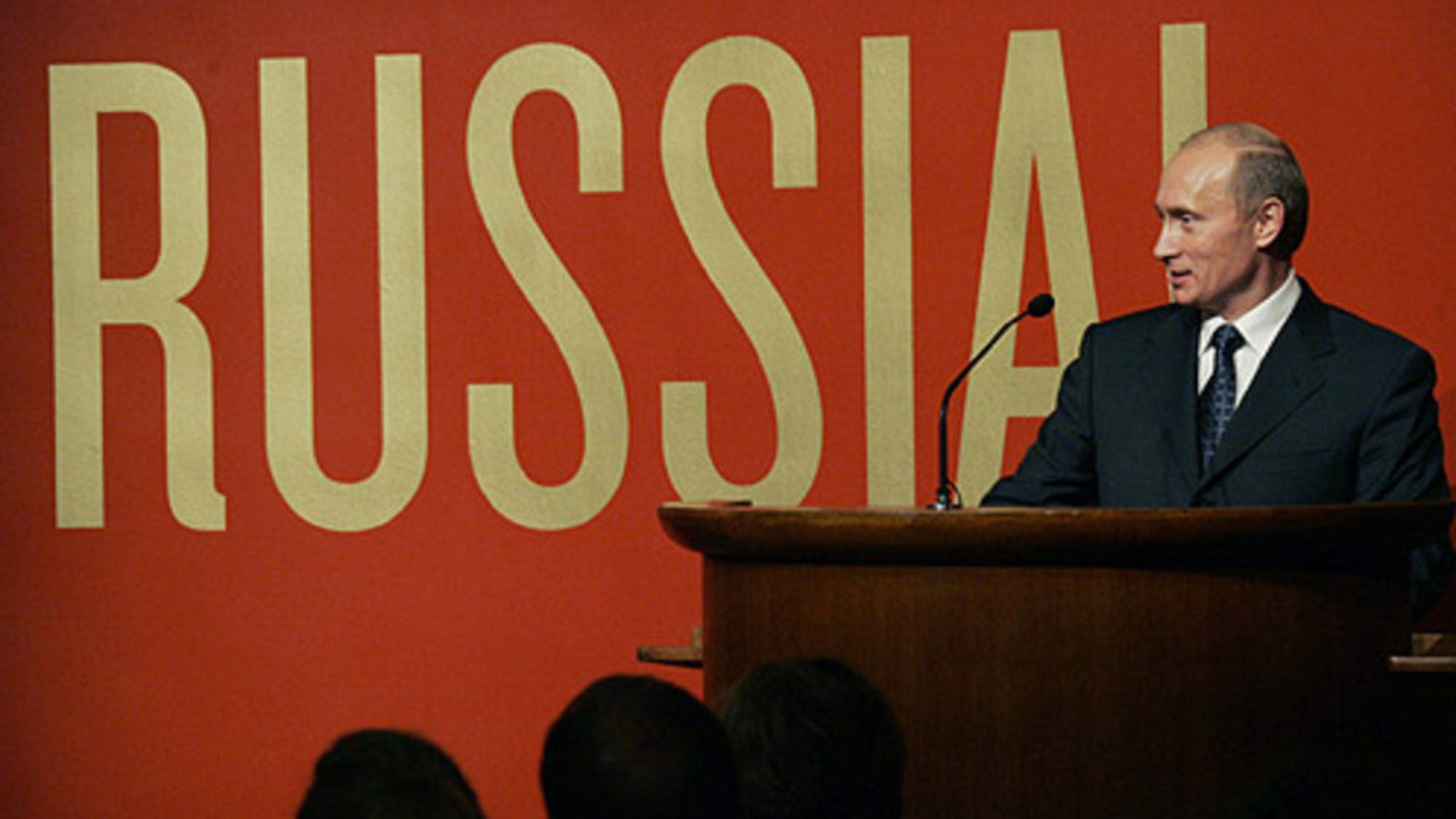 Putin in front of a gold &quot;Russia&quot; sign