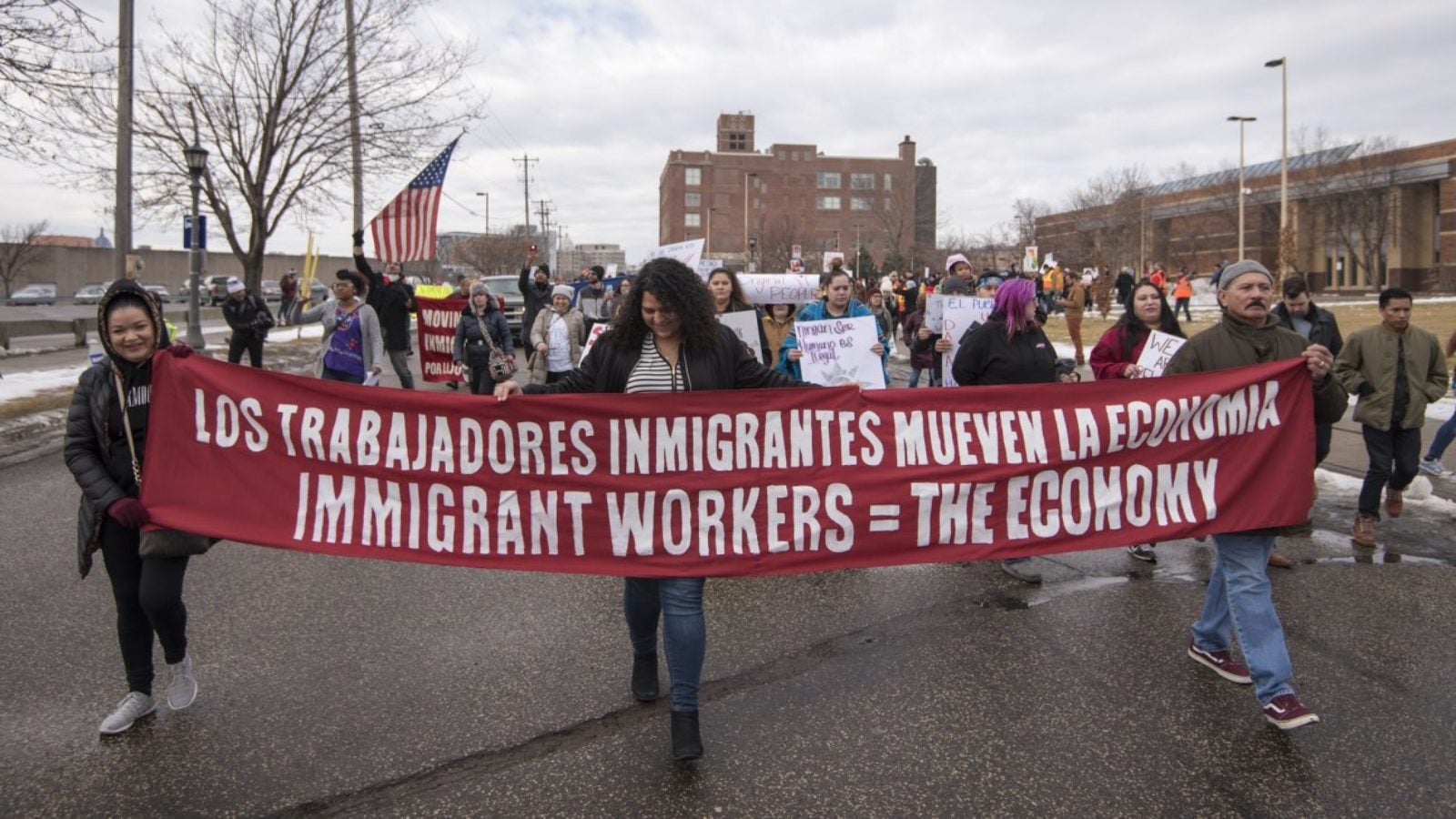 A group of protestors with pro-immigration signs in Spanish