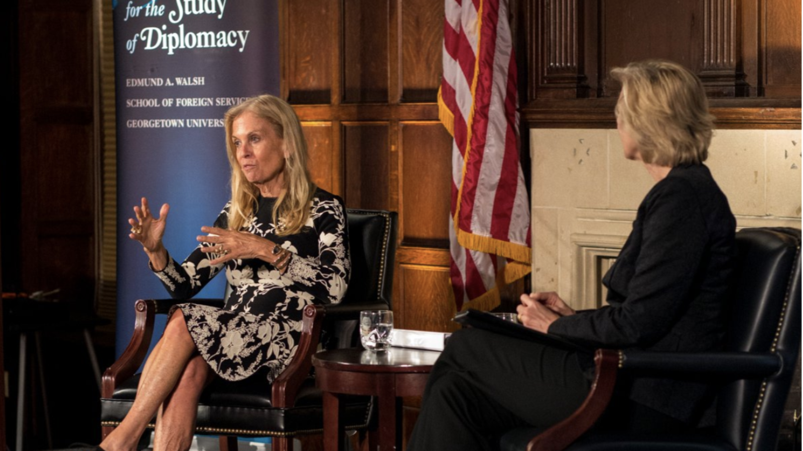 French Ambassador Jane Hartley sits on a stage in front of an American flag and a sign that reads, &quot;Institute for the Study of Diplomacy&quot;