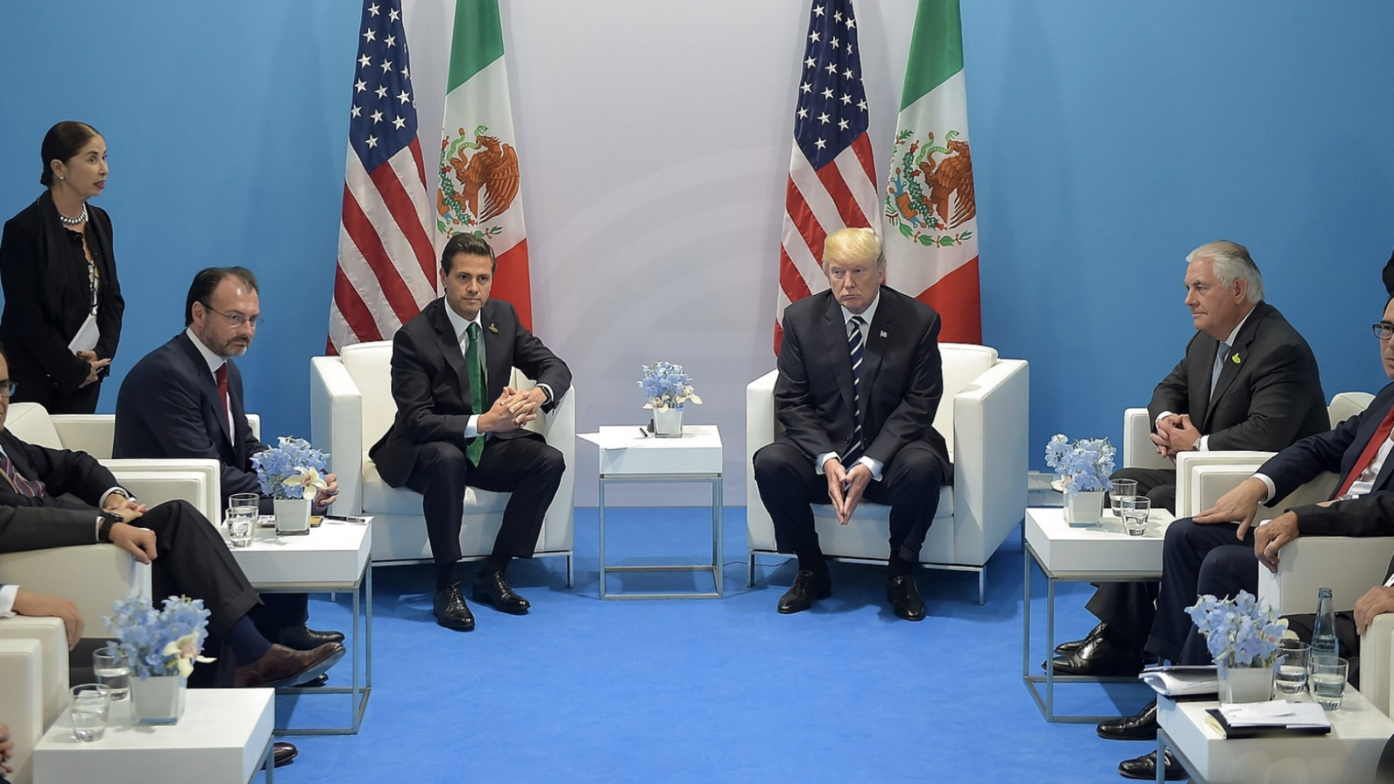 President Trump and President Enrique Peña Nieto sit next to each other in front of the U.S. and Mexican flags