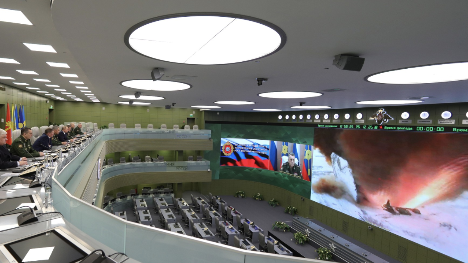 Members of the Russian Defense Ministry sit in a lecture hall watching an Avangard missile test launch on a screen