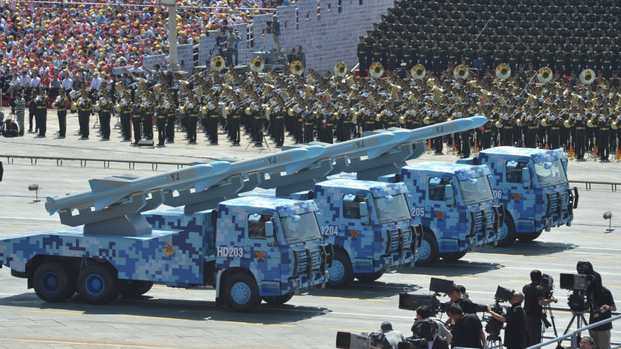 Four trucks carrying missiles marked YJ drive down the road as part of China&#039;s 70th National Day parade.