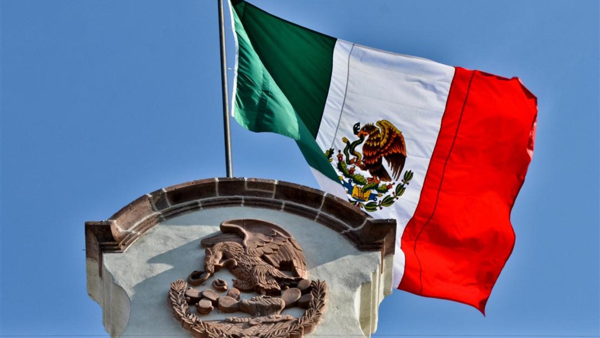 The Mexican flag on top of a building