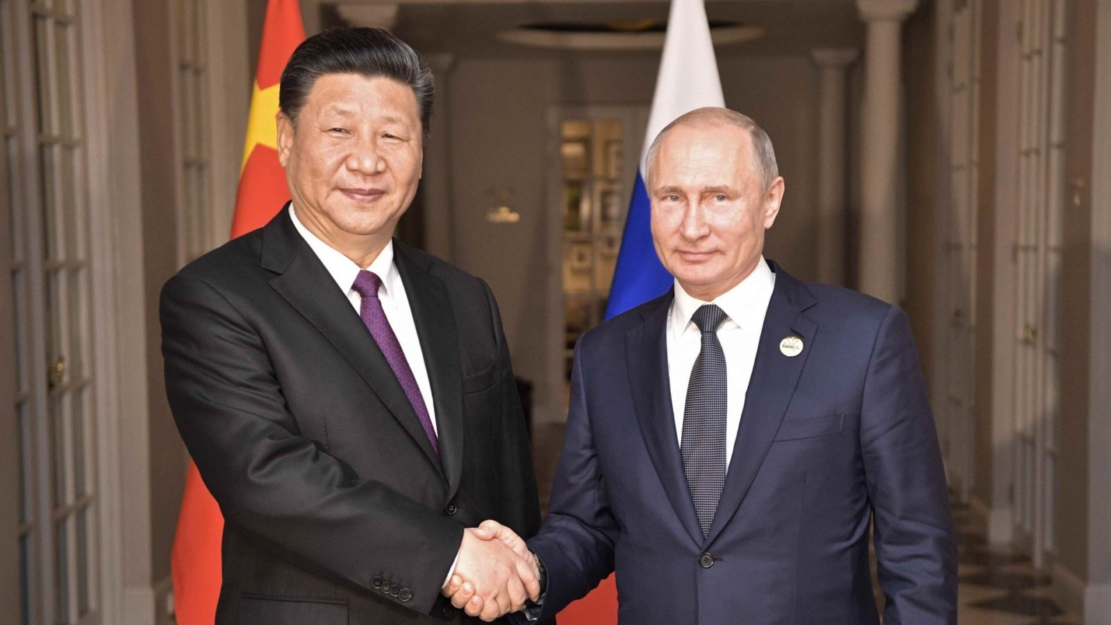 Xi Jinping and Vladimir Putin are shaking hands