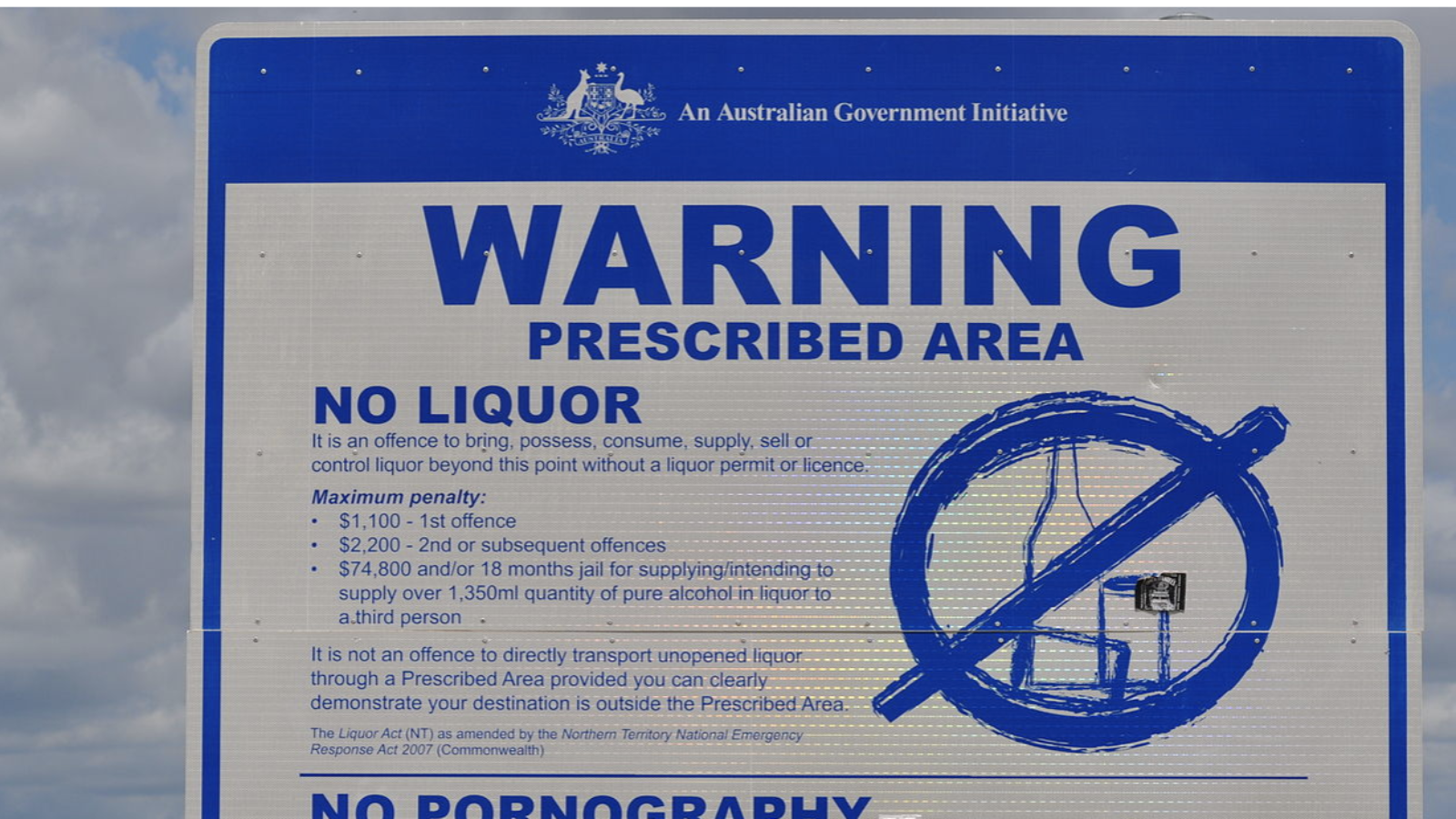 A government sign on a signpost in Australia that contains a warning about an alcohol prohibition in the area.