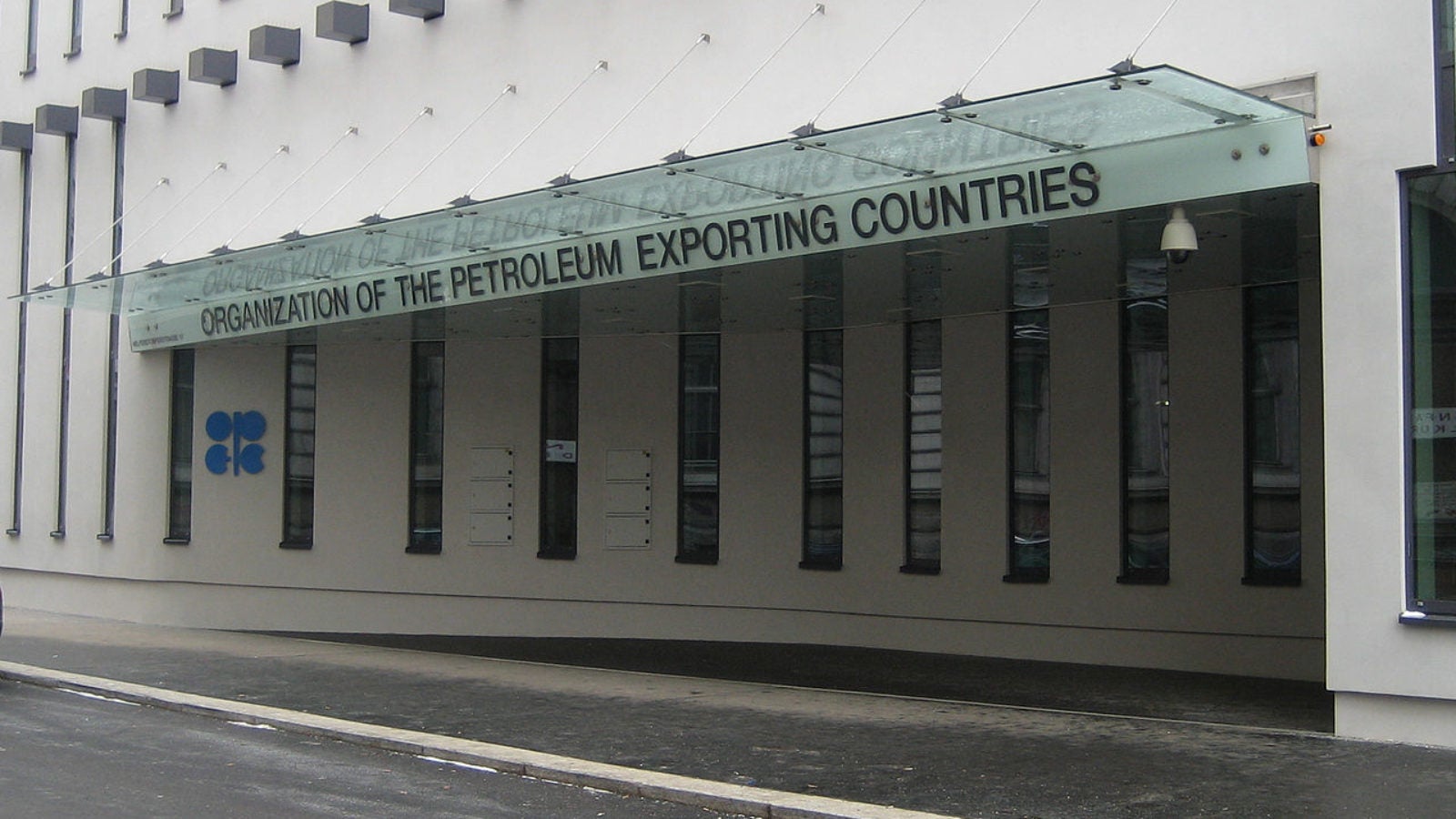 A gray building with the words &quot;Organization of the Petroleum Exporting Countries&quot; written on an overhang over the door.