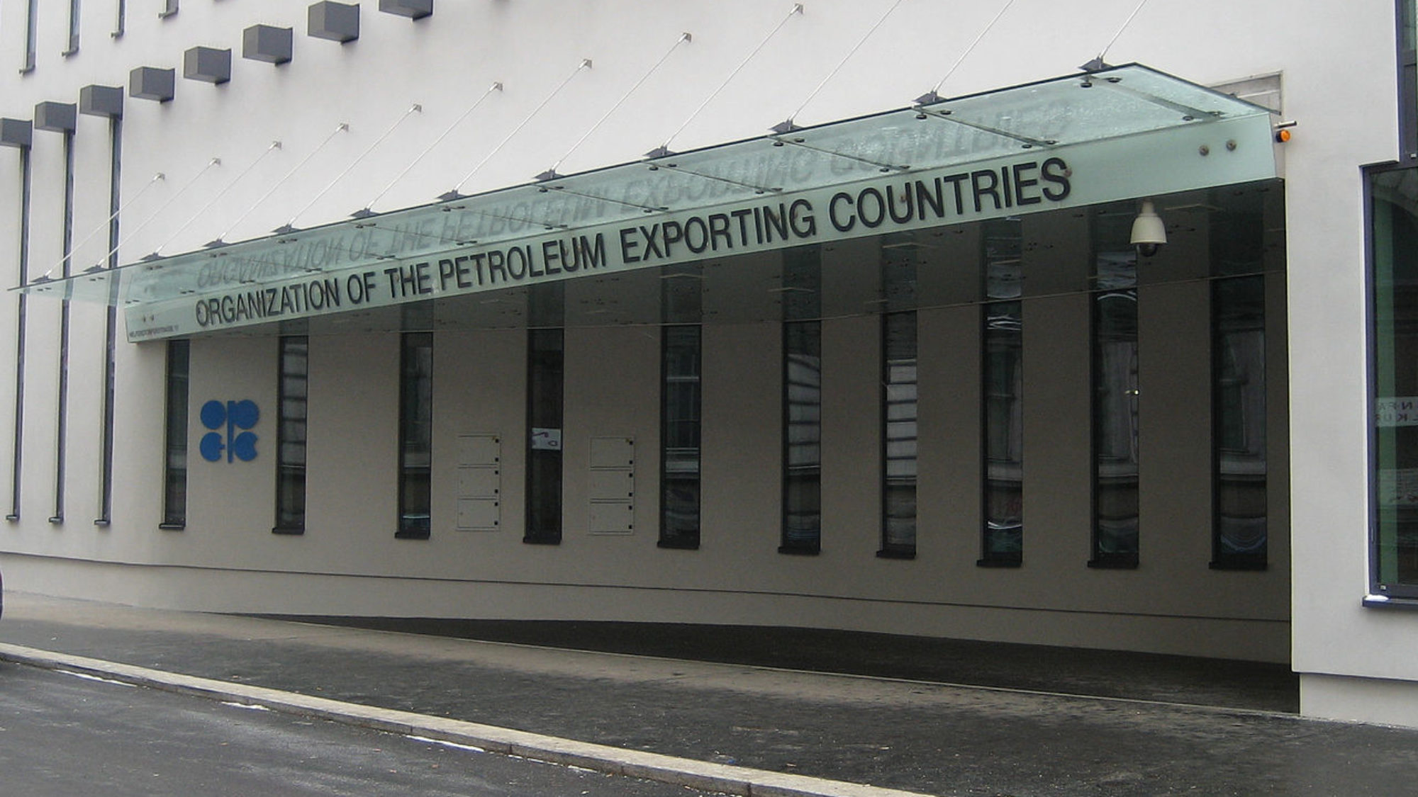 A gray building with the words &quot;Organization of the Petroleum Exporting Countries&quot; written on an overhang over the door.
