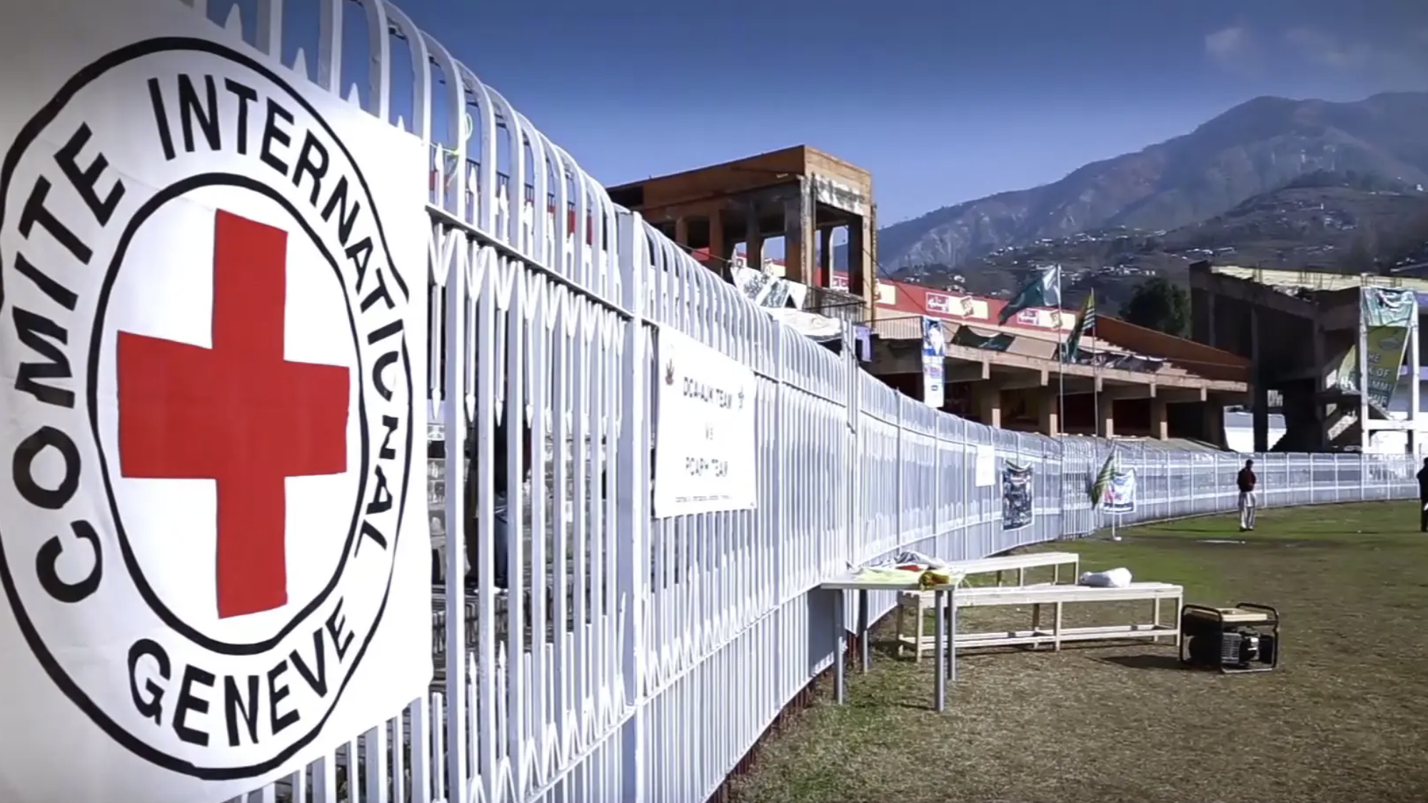 The International Committee of the Red Cross logo on a white fence.