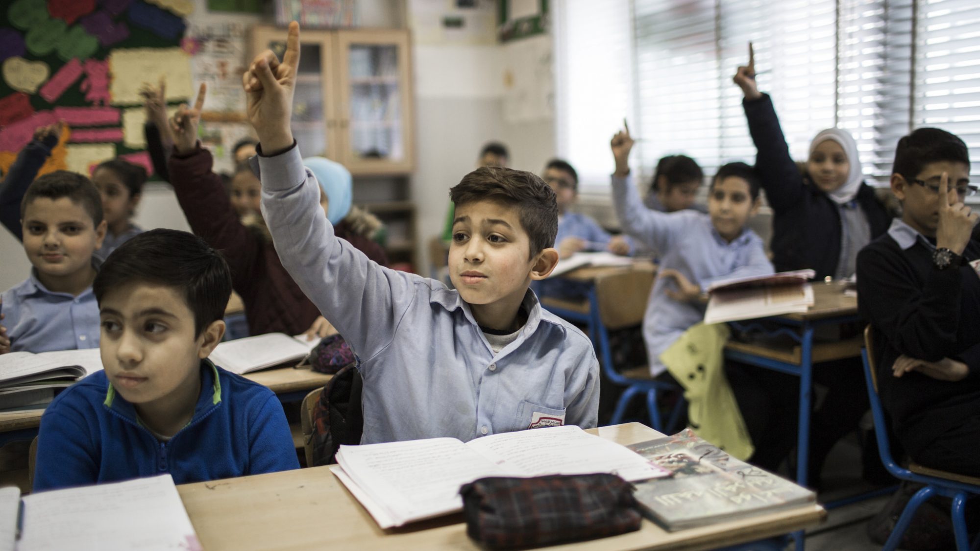 Students in Turkey raising their hands.