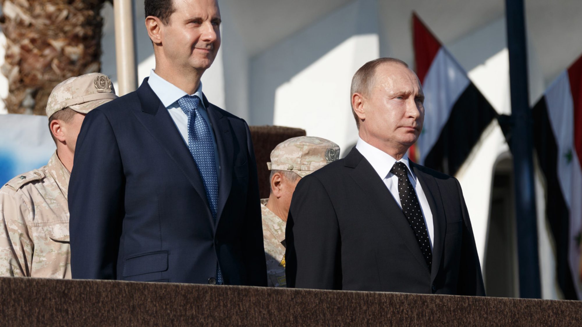 Putin and Syrian president stands