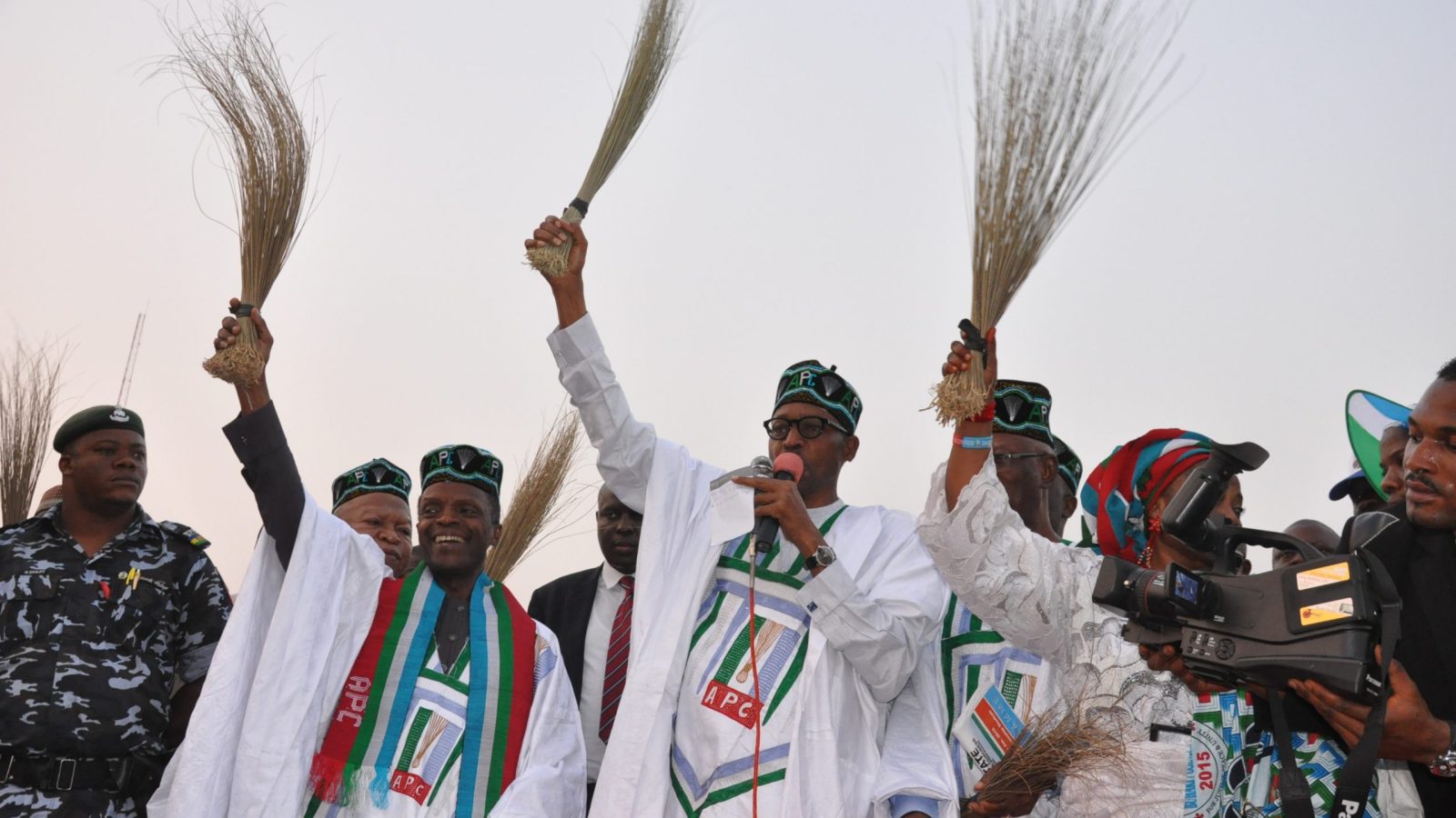 General Buhari holding a broom at a campign rally