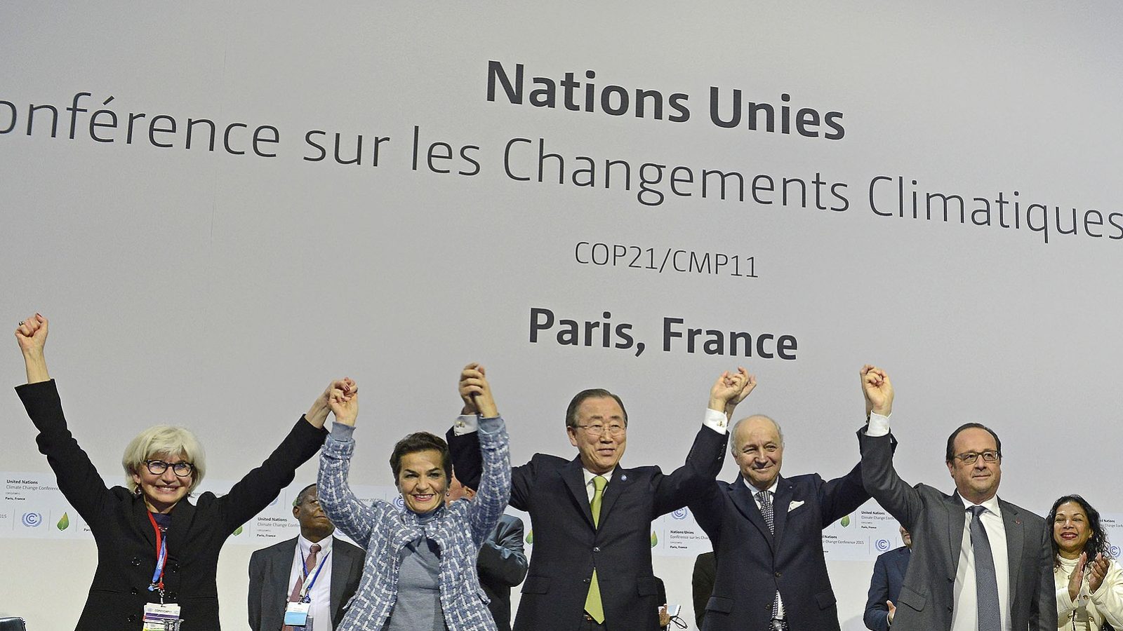 Participants of the plenary session of the COP21 for the adoption of the Paris Accord celebrate