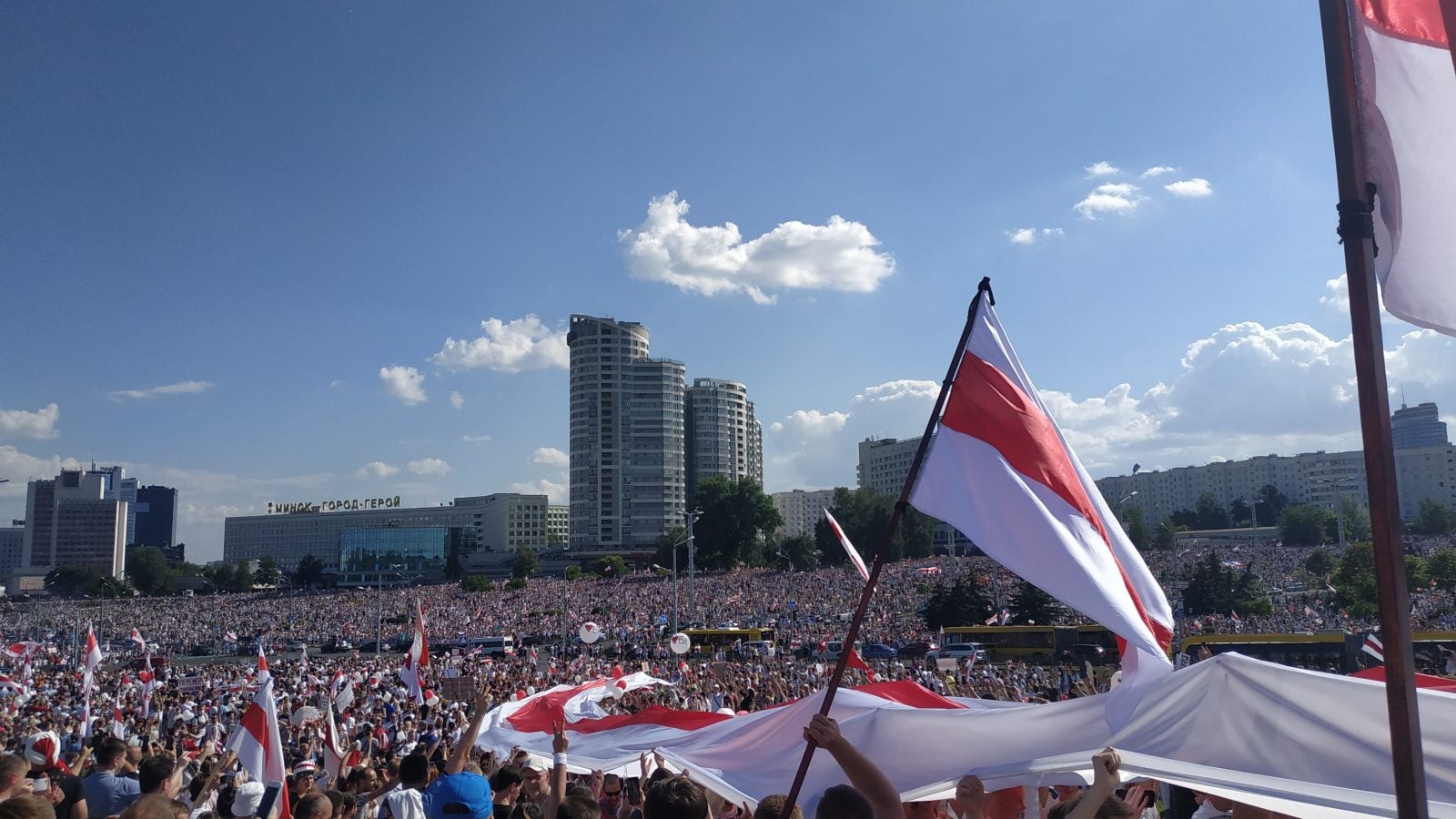 Protestors hold the Belarusian flag in Minsk