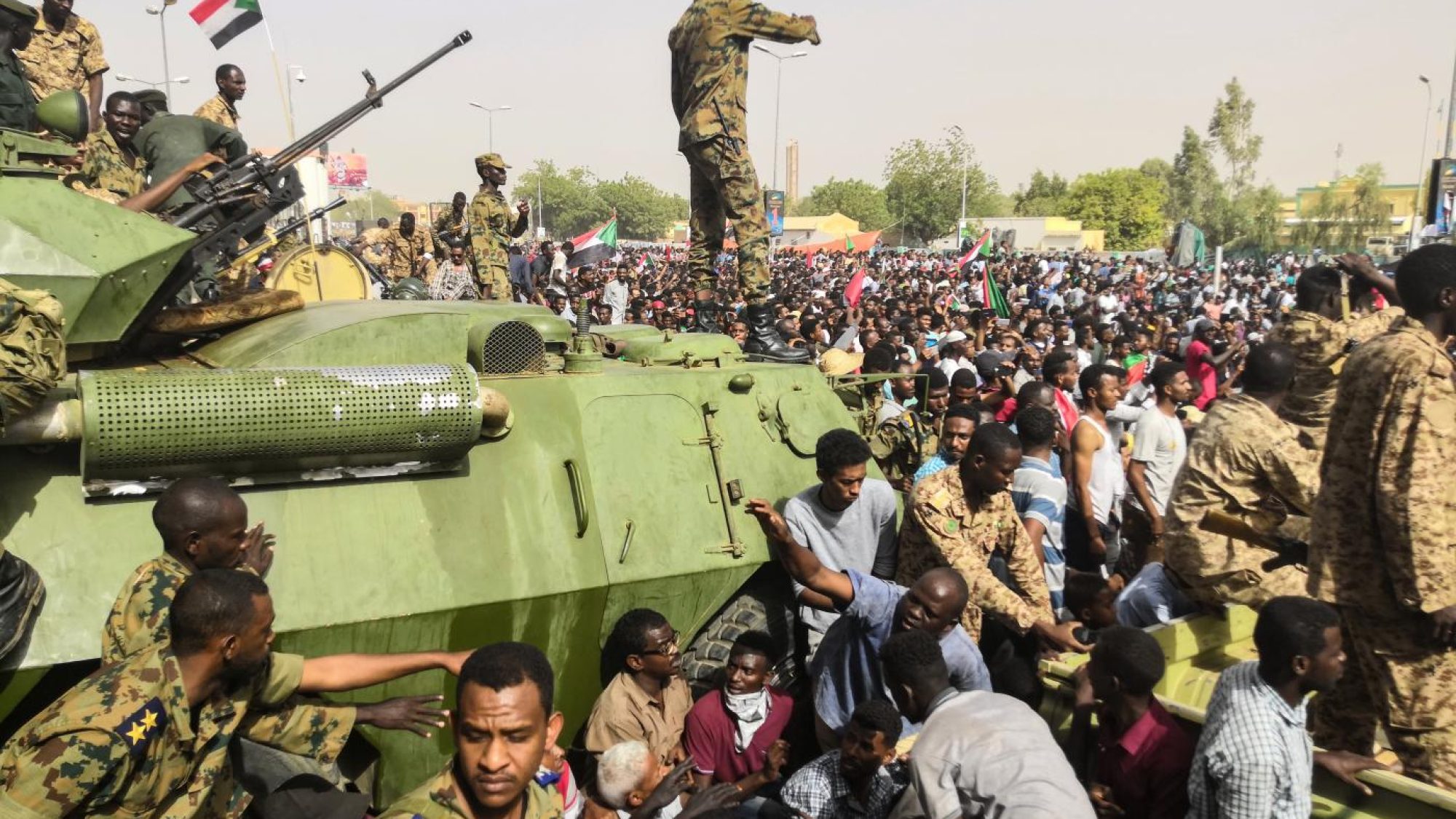 soldiers stand on tank in Sudan