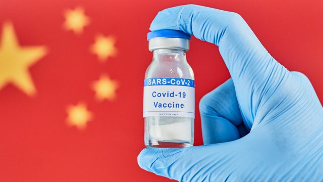COVID-19 Vaccine with Chinese Flag in the Background