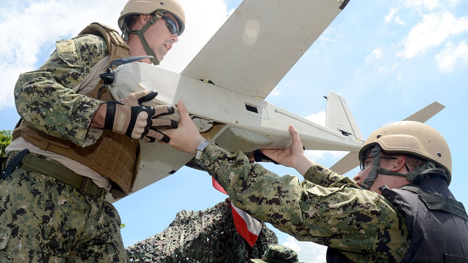 U.S. military members handing off a military drone