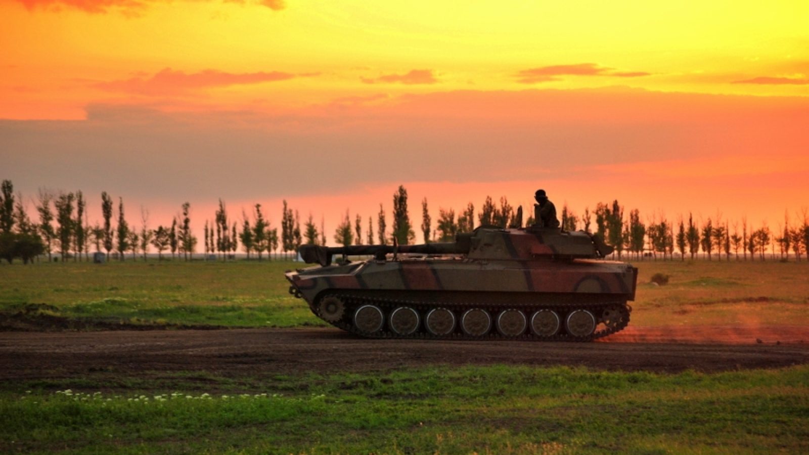 Battle tank photographed with the sky (sunset) in Eastern Ukraine