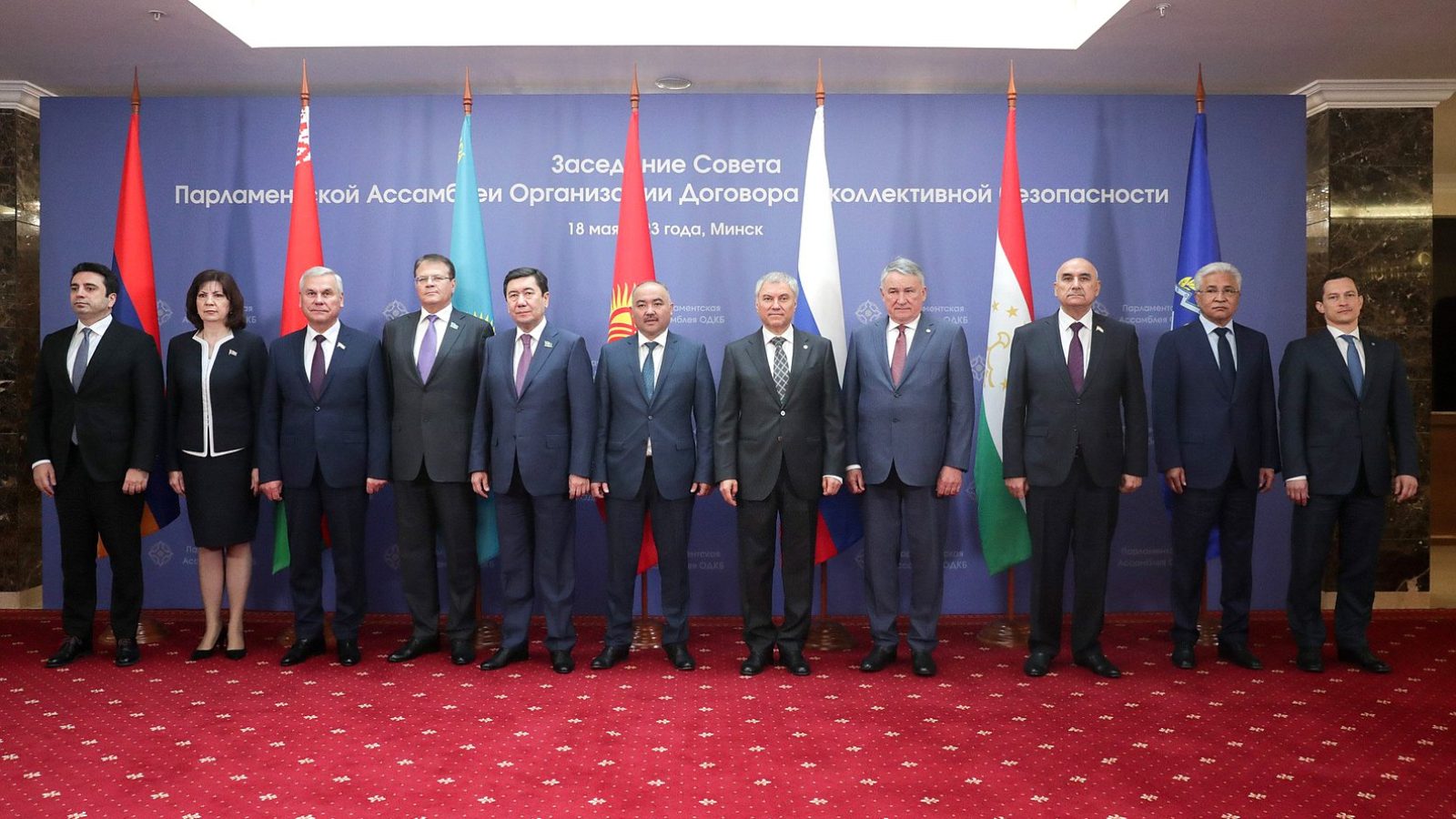 CSTO leaders posing in front of their flags at a meeting in Minsk