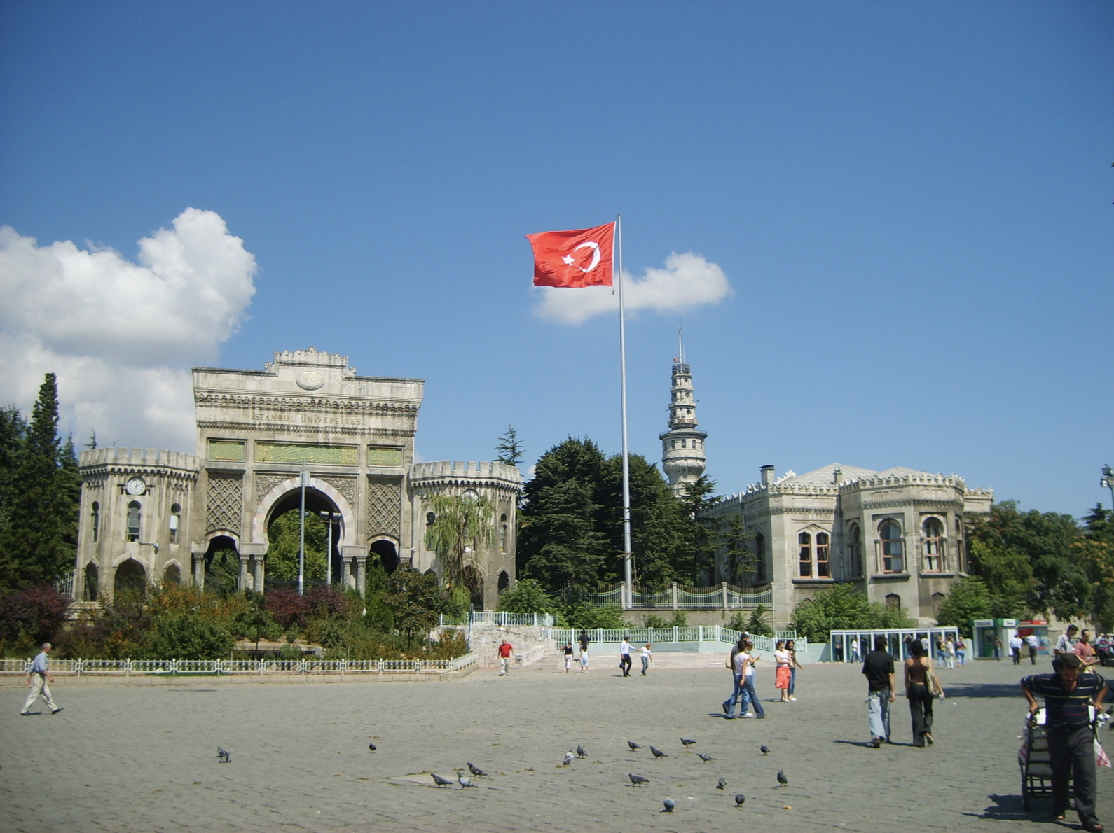 A Turkish flag flies in front of the main entrance of the gate of Istanbul University