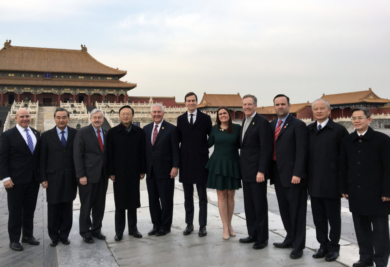 Senior U.S. and Chinese government officials pose for a photo in front of buildings in the Forbidden City, Beijing.