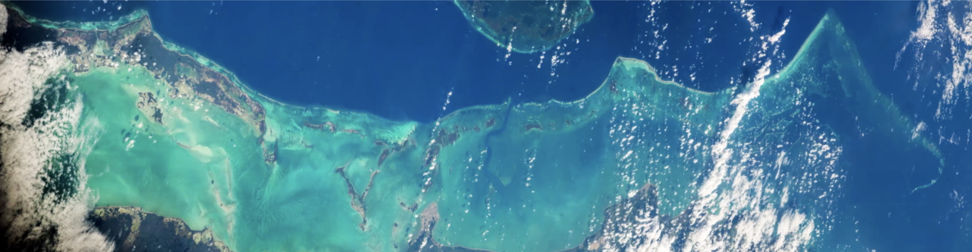 Clouds hover over a blue ocean.