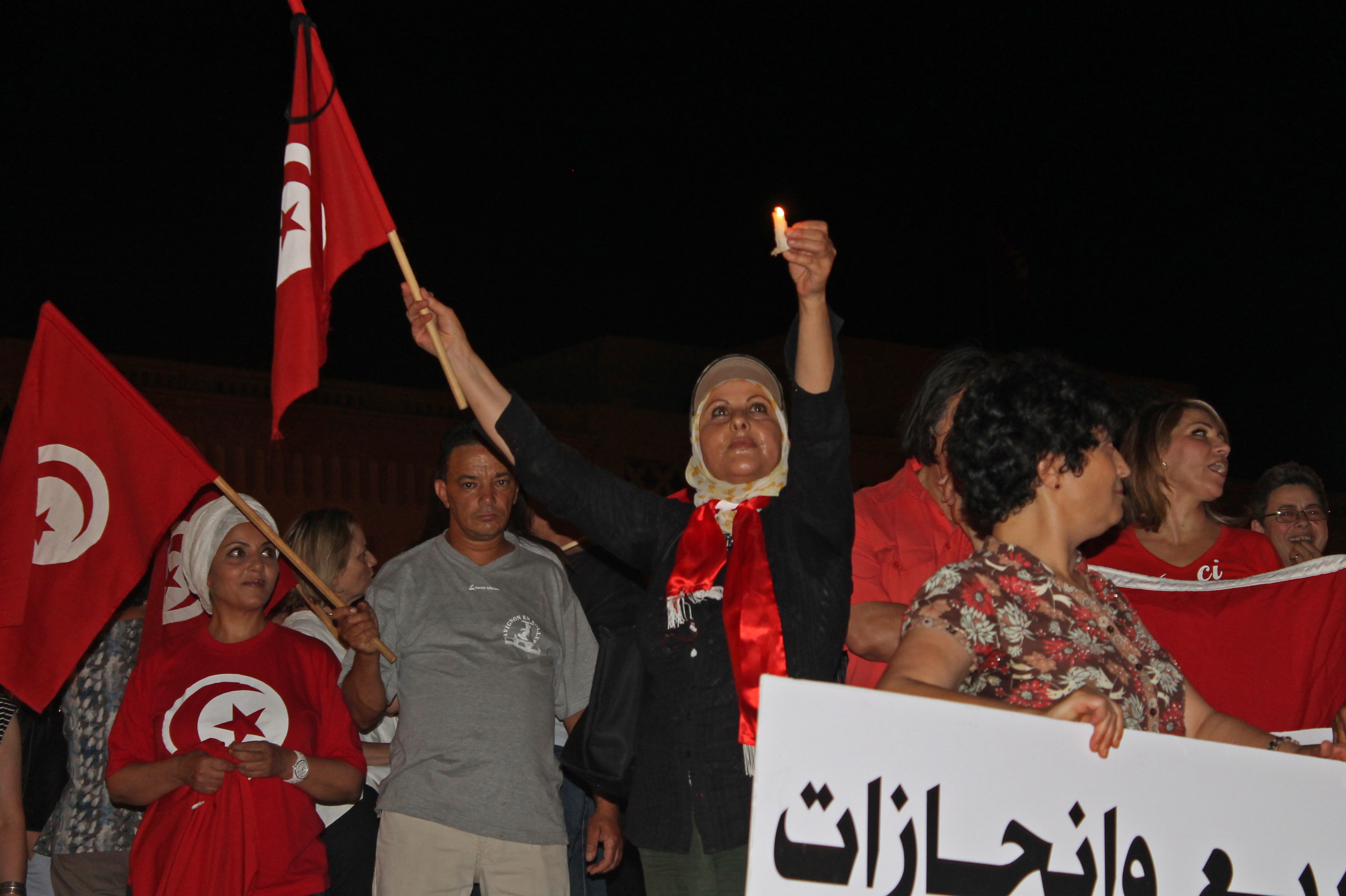 Group of anti-terrorism protestors with the Tunisian flag