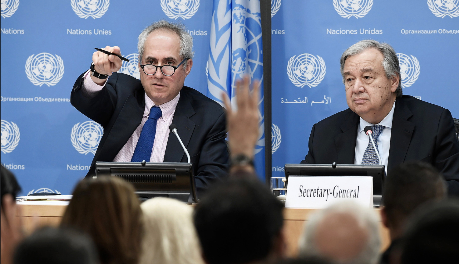 Stephane Dujarric and António Guterres take questions from a room of reporters.