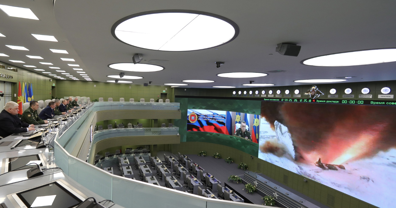 Members of the Russian Defense Ministry sit in a lecture hall watching an Avangard missile test launch on a screen