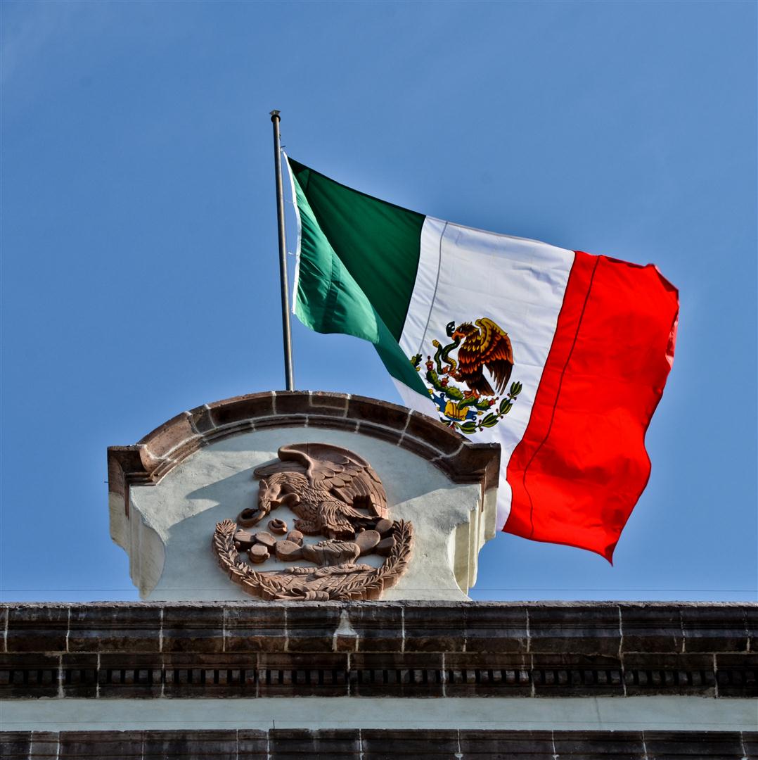 The Mexican flag on top of a building