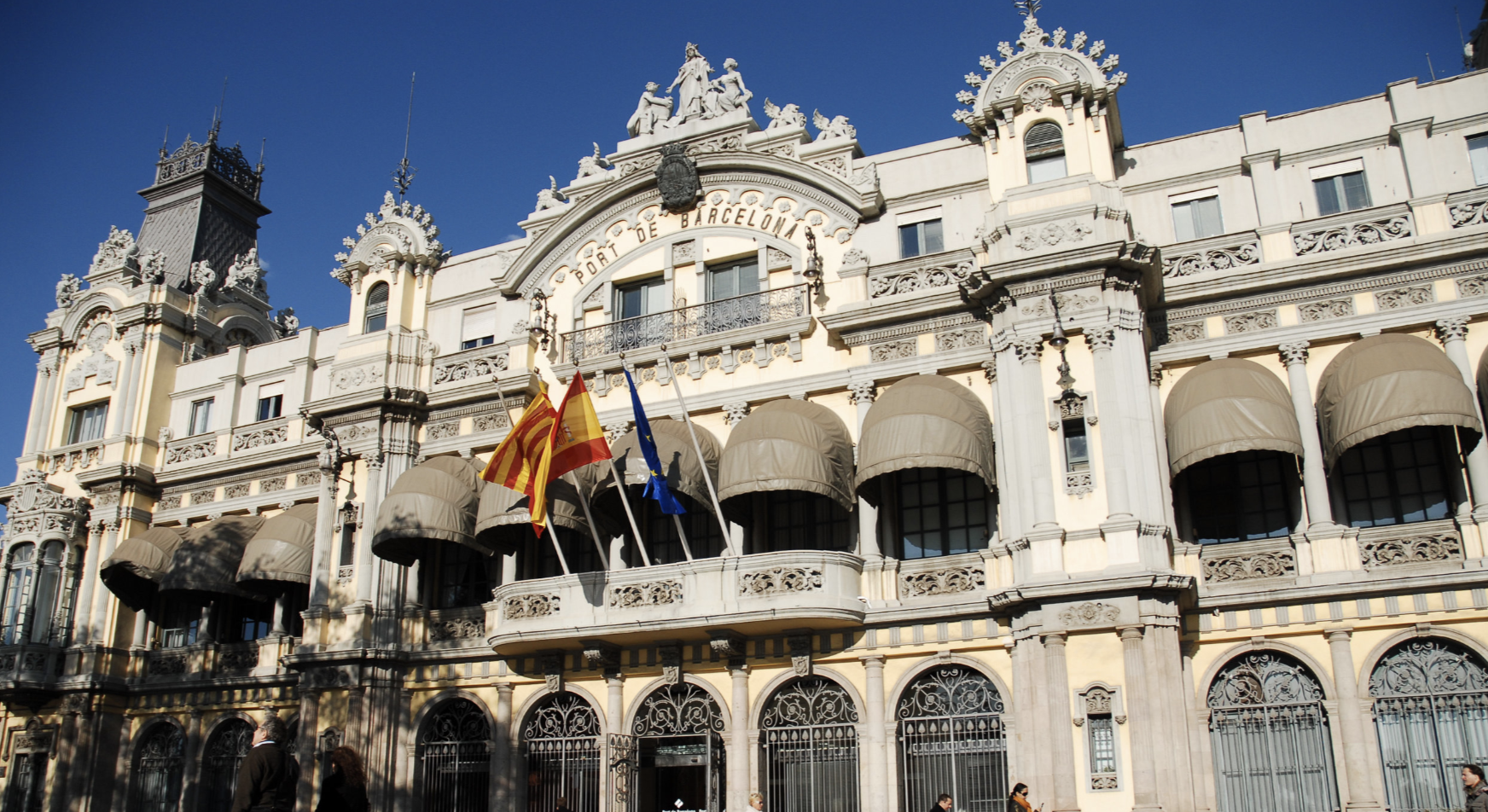An ornate stone building with the flags of Catalonia, Spain, and the EU on the front, and the words 