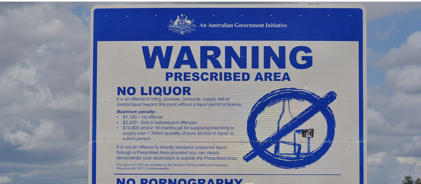 A government sign on a signpost in Australia that contains a warning about an alcohol prohibition in the area.