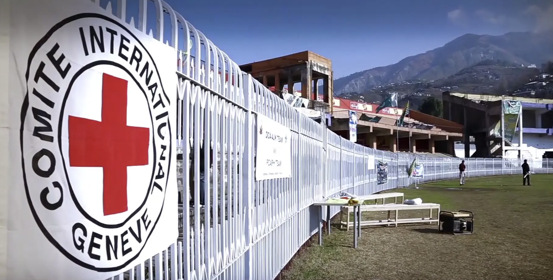 The International Committee of the Red Cross logo on a white fence.