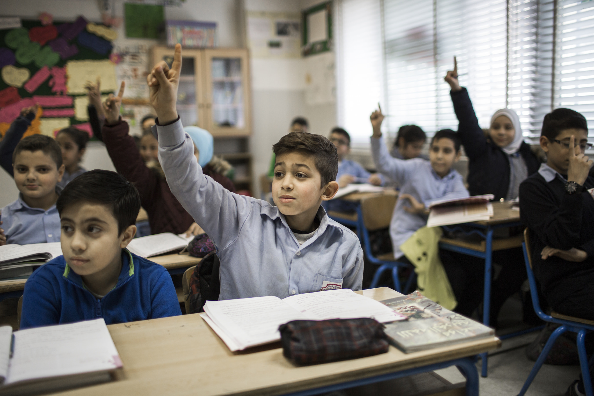 Students in Turkey raising their hands.