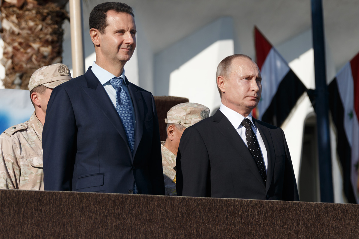 Putin and Syrian president stands