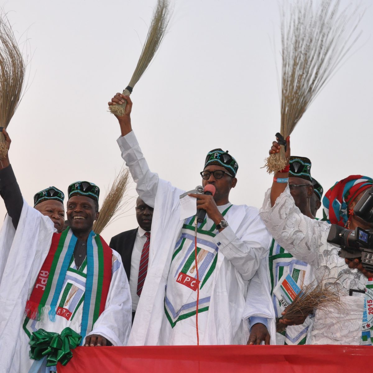 General Buhari holding a broom at a campign rally