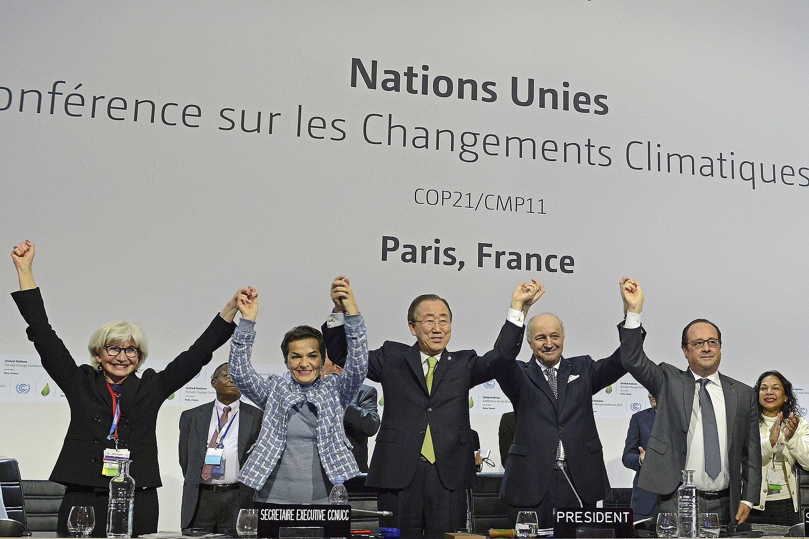 Participants of the plenary session of the COP21 for the adoption of the Paris Accord celebrate