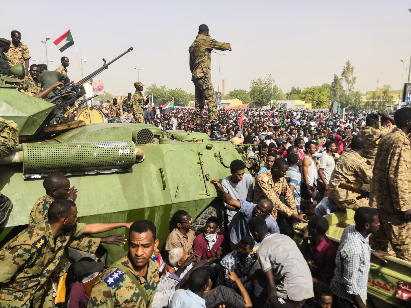 soldiers stand on tank in Sudan