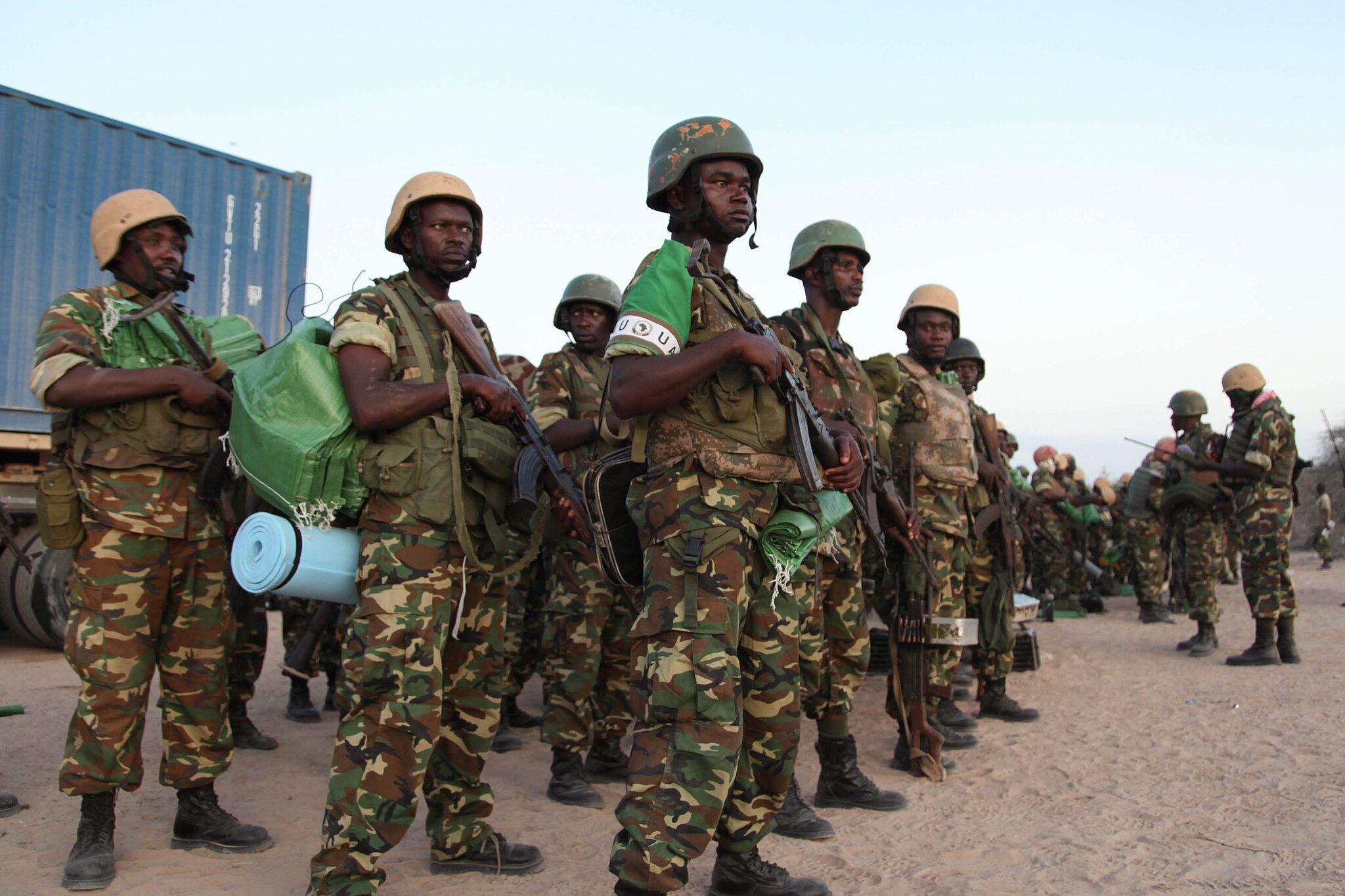 Soldiers standing in a line carrying guns